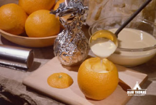 Make a simple breakfast in the outdoors using an orange peel as a muffin tin.