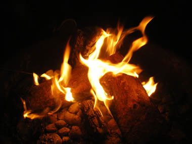 Fire warming up some briquettes that will be used to cook dinner