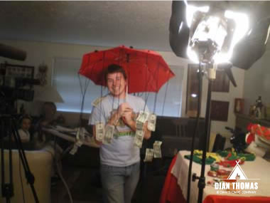 Happy camera man is being showered with money after filming at Dian Thoma's house.