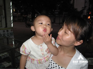 Cute Chinese girl blowing kisses after an amazing day learning about the people and culture in China.