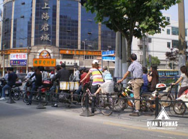Bikers waiting in a line for their turn to go in the bike lane.