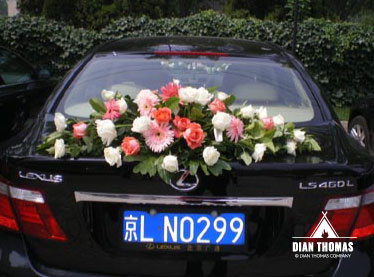 Beautiful wedding flowers decorate a bride and grooms car in Beijing, China.